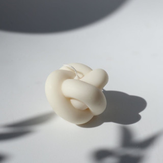 This is a natural candles and candle holders by Powered By People called the simple knot candle in standard