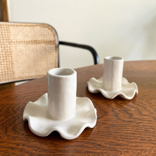 This is a white candles and candle holders by Sidney Field called ruffled candle holder in standard