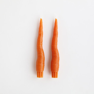 This is a orange candles and candle holders by Artifaqt called carrot taper beeswax candles (pair) in standard