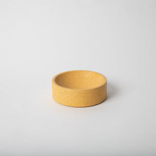 This is a yellow decorative object by Pretti.Cool called 5" Catch-All: Marigold Terrazzo in standard.