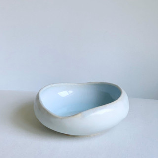 This is a white decorative object by Cloude Made called Lagoon Crater Bowl.