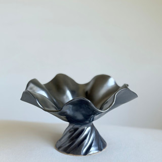 This is a black decorative objects by Cloude Made called black cascading pedestal bowl in standard