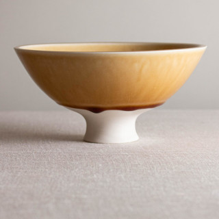 This is a yellow decorative objects by Lisa Fleming called butterscotch vessel with flared foot in standard