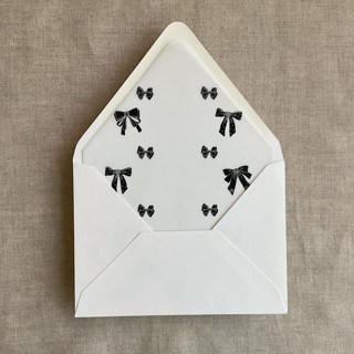 This is a black wedding envelopes by Ivory Invitations called black ribbon bow  printed vellum liner for a7 euro flap envelope | pack of 10 in standard