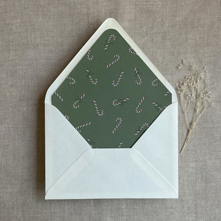 This is a green wedding envelopes by Ivory Invitations called mid green holiday candy cane printed envelope liner for a7 euro flap envelope  | pack of 10 in standard
