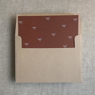 This is a copper wedding envelopes by Ivory Invitations called rust baby ribbon bows envelope liner for a7 square flap envelope | pack of 10 in standard