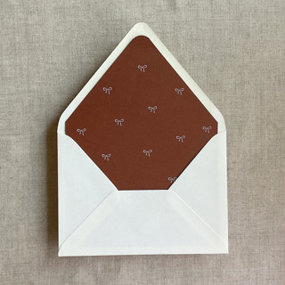 This is a copper wedding envelopes by Ivory Invitations called rust baby ribbon bows envelope liner for a7 euro flap envelope | pack of 10 in standard