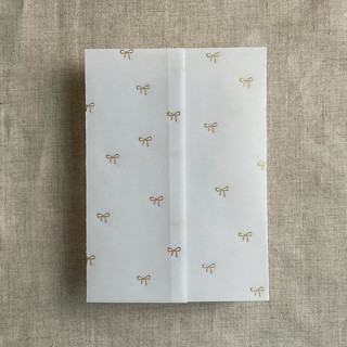This is a gold vellum wedding invitations by Ivory Invitations called baby ribbon bows gold foil stamping vellum wrap for 5x7 card | pack of 10 in standard