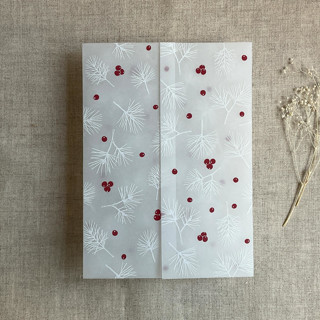 This is a white vellum wedding invitations by Ivory Invitations called holly berries white pine leaves printed vellum wrap for 5x7 card | pack of 10 in standard