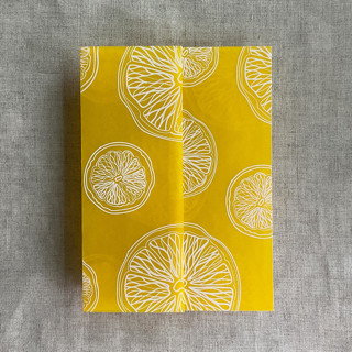 This is a yellow vellum wedding invitations by Ivory Invitations called white ink printed citrus celebration yellow vellum wraps for 5x7 card | pack of 10 in standard