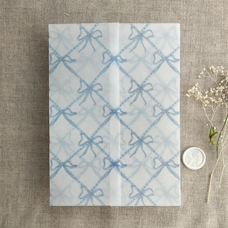 This is a blue vellum wedding invitations by Ivory Invitations called festive ribbon bow lattice sky blue printed vellum wrap for 5x7 card | pack of 10 in standard