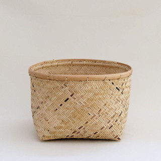 This is a beige accent pieces by Jennifer Abelev called rattan storage woven basket in standard