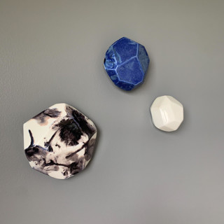 This is a multicolor sculpture art by Lauren Herzak Bauman called 3 geo wall stones in white, azul, and nebula in standard