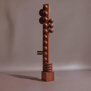 This is a brown sculpture art by Meso Casa LLC called nunca wood sculpture in standard