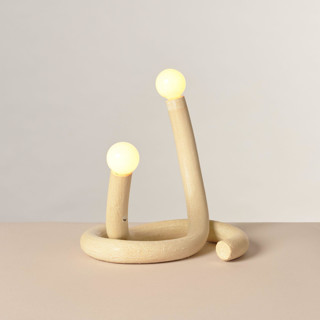 This is a white home decor by Rory Pots called embrace table lamp set in standard