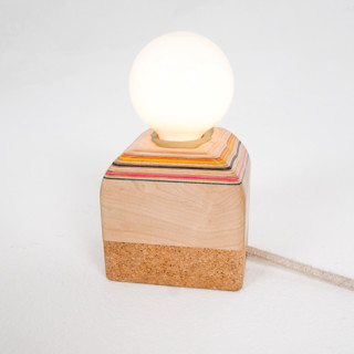 This is a white home decor by Koppa Wood called recycled skateboard base lamp in standard