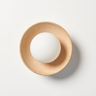 This is a beige home decor by Rory Pots called sounding sconce in standard
