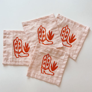This is a pink tableware by Julie Peach called pink cowboy boot cocktail napkins in standard