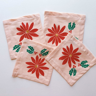 This is a pink tableware by Julie Peach called poinsettia cocktail napkin set in standard