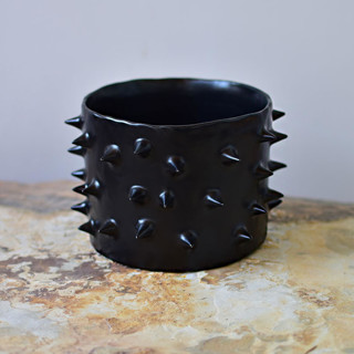 This is a black accent pieces by OWO Cerámica called spikes black ceramic handmade planter in standard