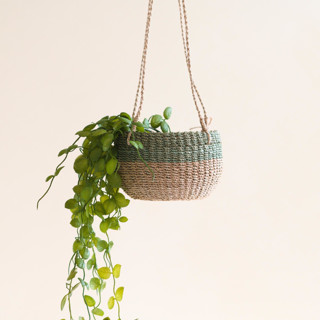 This is a green accent pieces by LIKHA called natural + sage round hanging planter in standard
