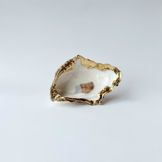 This is a white wedding accessories by Anna Sibley called gold leaf oyster shell wedding ring dish in standard