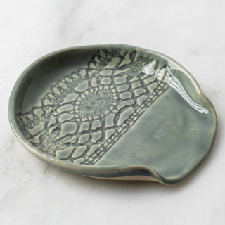 This is a green tableware by Handmade Studio TN called lace spoon rest - moss in standard
