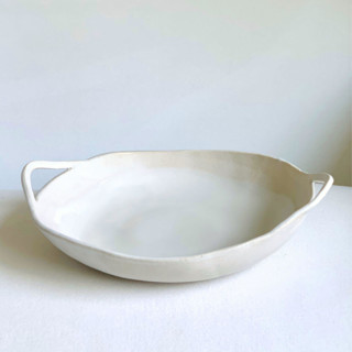 This is a white tableware by Cloude Made called wavy bowl with handles in standard