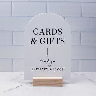 This is a white wedding signs by Willow and Barn called cards and gifts modern minimalist arch sign, white arch, 5"x7" in standard