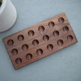 This is a brown tableware by Block and Bowl called walnut egg holder in standard