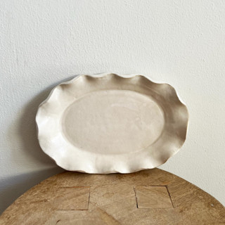 This is a white tableware by Sidney Field called ruffle platter in standard