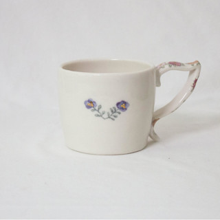 This is a white tableware by Erika Christine Ceramics called cornflower mug- blueberry in standard