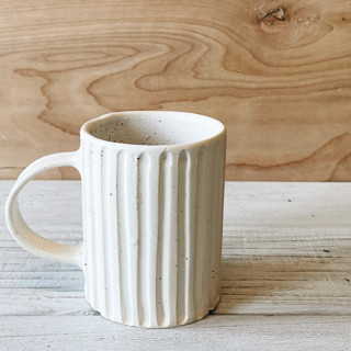 This is a beige tableware by Bridget Dorr called ceramic lined  mug in oatmeal in standard