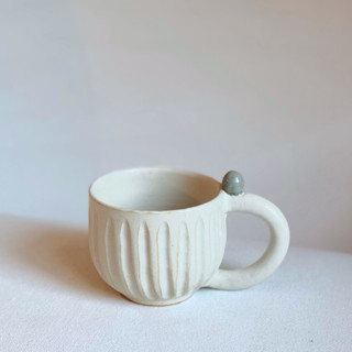 This is a white tableware by Cloude Made called fluted marble mug in standard