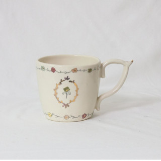 This is a beige tableware by Erika Christine Ceramics called cornflower mug- sage in standard