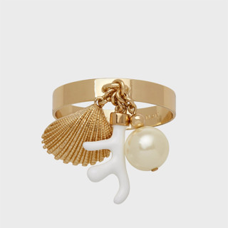 This is a gold tableware by Joanna Buchanan called coral and shell skinny napkin rings, cream, set of four in standard