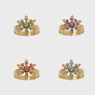 This is a multicolor tableware by Joanna Buchanan called classic snowflake skinny napkin rings, pastel, set of four in standard
