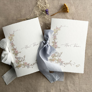 This is a blue vow books by Ivory Invitations called marianne's bouquet vow books set of 2 books in standard