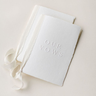 This is a white vow books by Studio Lavender called embossed wedding vow books, set of two in standard