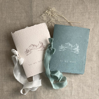 This is a blue vow books by Ivory Invitations called blue mountain wedding vow books | set of 2 books | includes 1 her vows and 1 his vows in standard