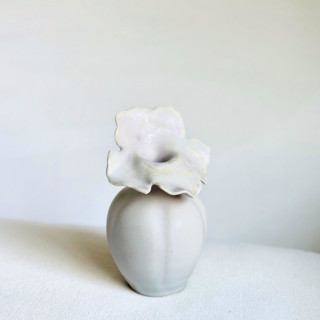 This is a white vases by Cloude Made called floral fluted bud vase in standard
