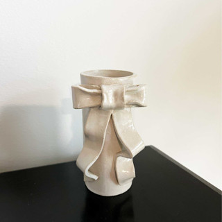 This is a white vases by Sidney Field called ribbon bow vase - small in standard