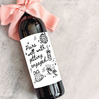 This is a white wedding gifts by The Pretty Little Mess called engagement wine label | pairs well with getting engaged in standard