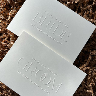 This is a natural wedding gifts by Eva Tadros called luxe embossed cream bride & groom cards, set of 2 in standard