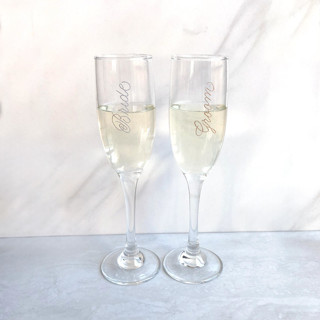 This is a clear wedding gifts by Charlotte Noordzij called bride & groom champagne flute set of 2 - engraved in standard