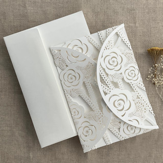 This is a white vellum wedding invitations by Ivory Invitations called white rose floral lace lasercut petal pocket for 5x7 inch invitation | pack of 10 | envelopes included in standard