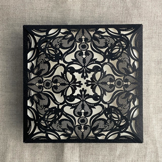 This is a black vellum wedding invitations by Ivory Invitations called black glitter lace laser cut square petal fold | pack of 10 in standard