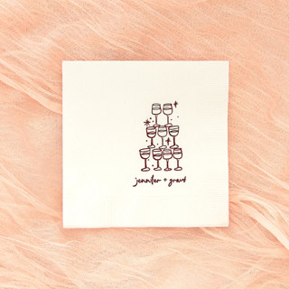 This is a white decorative paper napkins by ForYourParty called kitschy cocktail hour pyramid toast napkin, cocktail size, set of 100 in standard