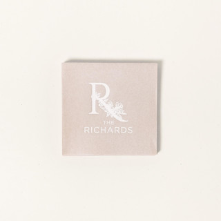 This is a beige decorative paper napkins by ForYourParty called floral family name napkin, cocktail size, set of 100 in standard