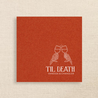 This is a orange decorative paper napkins by Papel Custom Design called “til death” terracotta linen-like napkin with skeleton toast design in standard